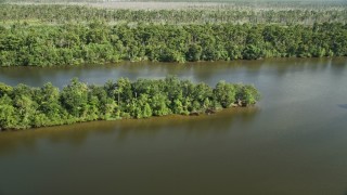 AX60_083E - 5K aerial stock footage fly over a swamp to reveal a river and a dirt road in St. John the Baptist Parish, Louisiana