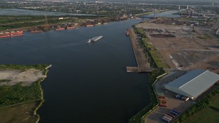 5K aerial stock footage approach a barge sailing on Industrial Canal at sunset, New Orleans, Louisiana Aerial Stock Footage | AX61_004