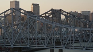 5K aerial stock footage of light traffic on Crescent City Connection Bridge at sunset, New Orleans, Louisiana Aerial Stock Footage | AX61_024E