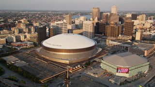 AX61_028E - 5K aerial stock footage flyby Superdome, reveal Downtown New Orleans skyscrapers, Louisiana, sunset