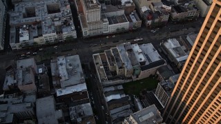 AX61_046 - 5K aerial stock footage of bird's eye view of the Bourbon and Canal Street intersection at sunset, Downtown New Orleans, Louisiana