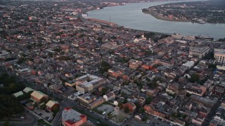 5K aerial stock footage of the French Quarter and skyscrapers in Downtown New Orleans at sunset, Louisiana Aerial Stock Footage | AX61_060E