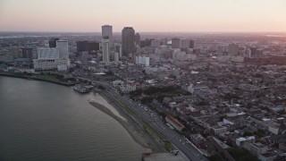 5K aerial stock footage of skyscrapers in Downtown New Orleans seen from the Mississippi River at sunset, Louisiana Aerial Stock Footage | AX61_063