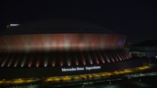 5K aerial stock footage of ascending from the Mercedes-Benz Superdome at night, New Orleans, Louisiana Aerial Stock Footage | AX62_001