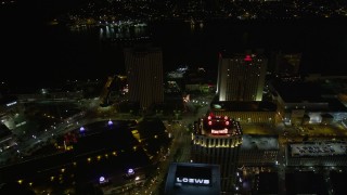 5K aerial stock footage follow Poydras Street to hotels in Downtown New Orleans at night, Louisiana Aerial Stock Footage | AX62_008E