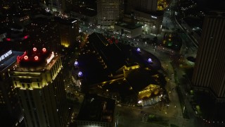 5K aerial stock footage follow Convention Center Boulevard to approach hotels and Harrah's casino in Downtown New Orleans at night, Louisiana Aerial Stock Footage | AX62_018