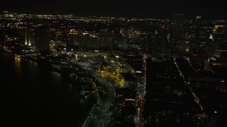 5K aerial stock footage tilt from Jax Brewery to reveal Downtown New Orleans at night, Louisiana Aerial Stock Footage | AX62_029E