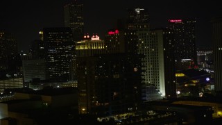 5K aerial stock footage flyby Harrah's and Hilton Riverside in Downtown New Orleans at night, Louisiana Aerial Stock Footage | AX62_034