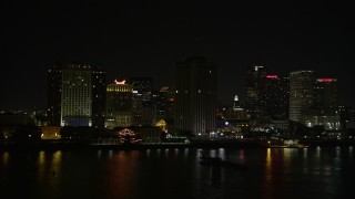 AX62_036E - 5K aerial stock footage flyby oil tanker sailing near Downtown New Orleans at night, Louisiana