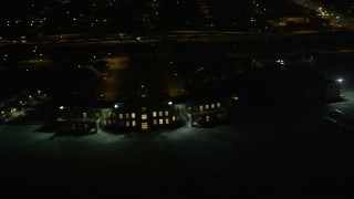 AX63_001 - 5K aerial stock footage flyby main terminal of the New Orleans Lakefront Airport at night, Louisiana