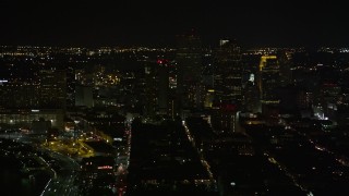 5K aerial stock footage of Downtown New Orleans at night, seen from the French Quarter, Louisiana Aerial Stock Footage | AX63_004E