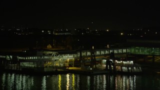 5K aerial stock footage flyby signage to reveal the Algiers Ferry Terminal at night, Algiers, New Orleans, Louisiana Aerial Stock Footage | AX63_009