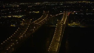 5K aerial stock footage orbit top of Crescent City Connection Bridge at night to reveal Downtown New Orleans, Louisiana Aerial Stock Footage | AX63_015E