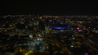 5K aerial stock footage of a reverse view  Superdome and Downtown New Orleans at night in Louisiana Aerial Stock Footage | AX63_027