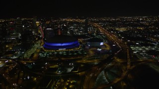 5K aerial stock footage follow Interstate 10 to the interchange and the Superdome at night in Downtown New Orleans, Louisiana Aerial Stock Footage | AX63_039E