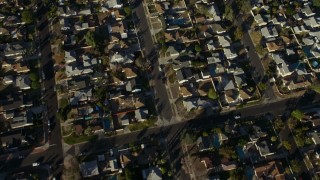 AX64_0033E - 5K aerial stock footage of suburban homes, and reveal Canyon Plaza Shopping Center in Sun Valley, California