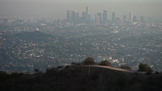 5K aerial stock footage fly over the Hollywood Hills to reveal Downtown Los Angeles and city sprawl, California Aerial Stock Footage | AX64_0070E