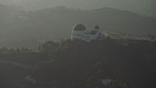 5K aerial stock footage flyby the Griffith Observatory in haze, Los Angeles, California Aerial Stock Footage | AX64_0072E