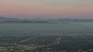 AX64_0158 - 5K aerial stock footage of Santa Susana Mountains and neighborhoods in San Fernando Valley, Los Angeles, California, twilight