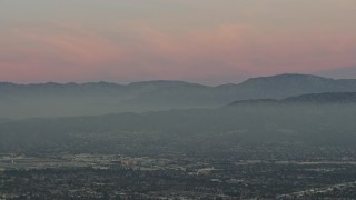 5K aerial stock footage of San Gabriel Mountains from across the San Fernando Valley, Los Angeles, California, twilight Aerial Stock Footage | AX64_0159