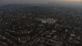 5K aerial stock footage of apartment buildings and urban homes, reveal Downtown Los Angeles skyline, Los Feliz, California, twilight Aerial Stock Footage | AX64_0174E