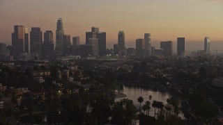 5K aerial stock footage of Downtown Los Angeles in haze seen from Echo Lake at twilight, California Aerial Stock Footage | AX64_0181E