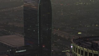 5K aerial stock footage tracking a police helicopter flying over Downtown Los Angeles, California, twilight Aerial Stock Footage | AX64_0197