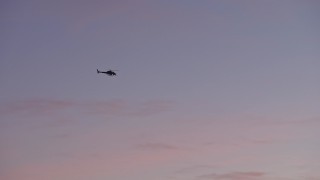 5K aerial stock footage of a police helicopter in the sky, Los Angeles, California, twilight Aerial Stock Footage | AX64_0203