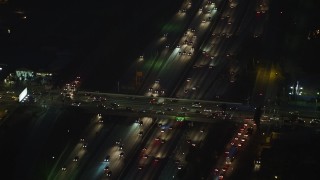 AX64_0276E - 5K aerial stock footage of Interstate 10 and cars on the Arlington Avenue Overpass, Los Angeles, California, night