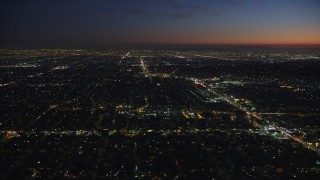 AX64_0279E - 5K aerial stock footage of West Adams neighborhood around Crenshaw Boulevard in Los Angeles, California, night