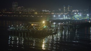 5K aerial stock footage flyby the end of Santa Monica Pier, Los Angeles, California, night Aerial Stock Footage | AX64_0302E