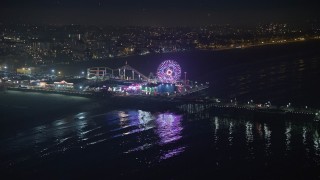 AX64_0306E - 5K aerial stock footage approach the Pacific Wheel at Santa Monica Pier, Los Angeles, California, night