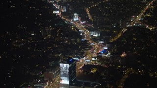 AX64_0327E - 5K aerial stock footage approach and tilt to the Sunset Strip, West Hollywood, California, night