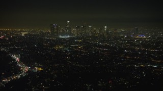 5K aerial stock footage of a view of the Downtown Los Angeles skyline and city sprawl, California, night Aerial Stock Footage | AX64_0344