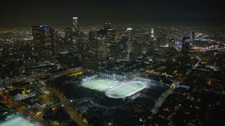 5K aerial stock footage approach and fly over sports fields and Downtown Los Angeles skyline at night, California Aerial Stock Footage | AX64_0354E