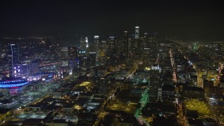 AX64_0360E - 5K aerial stock footage of Downtown Los Angeles skyscrapers, reveal Staples Center, California, night