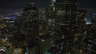 AX64_0370E - 5K aerial stock footage flyby Los Angeles City Hall and then over the Downtown Los Angeles skyline, California, night