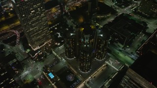 AX64_0394 - 5K aerial stock footage tilt to bird's eye of Westin Bonaventure Hotel and city streets, Downtown Los Angeles, California, night