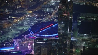 5K aerial stock footage of passing Ritz-Carlton Hotel to focus on Staples Center, Downtown Los Angeles, California, night Aerial Stock Footage | AX64_0406