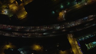 AX64_0427E - 5K aerial stock footage tilt to bird's eye view of heavy traffic on Interstate 5, Burbank, California night