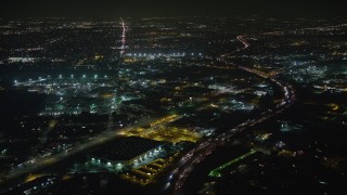 5K aerial stock footage of Interstate 5 and San Fernando Road around warehouse building, Sun Valley, California, night Aerial Stock Footage | AX64_0437E