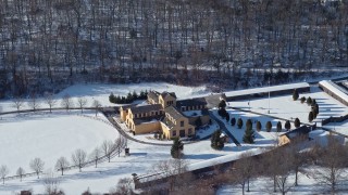 AX66_0005E - 4.8K aerial stock footage of church in snow in Old Bethpage, New York