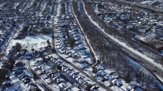 4.8K aerial stock footage of neighborhoods and reveal highway in snow, Syosset, New York Aerial Stock Footage | AX66_0013E