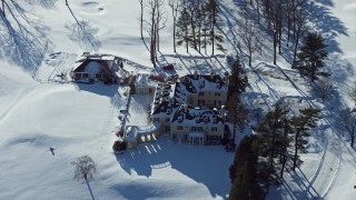 4.8K aerial stock footage of a snow covered mansion, Jericho, New York Aerial Stock Footage | AX66_0017E