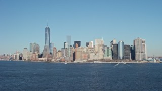 4.8K aerial stock footage tilt from New York Harbor to reveal skyline in Lower Manhattan, New York City Aerial Stock Footage | AX66_0133E