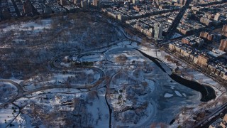 AX66_0194E - 4.8K aerial stock footage of Central Park skating rink in snow, Manhattan, New York City