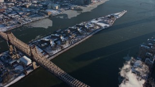 AX66_0217E - 4.8K aerial stock footage of the Goldwater Specialty Hospital on Roosevelt Island with snow, East River, New York