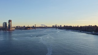 4.8K aerial stock footage follow East River to approach Williamsburg Bridge, New York City at sunset Aerial Stock Footage | AX66_0228