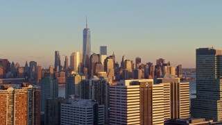 4.8K aerial stock footage of the Lower Manhattan skyline across the river, New York City, sunset Aerial Stock Footage | AX66_0248E