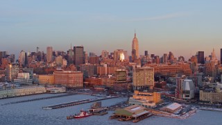 AX66_0268E - 4.8K aerial stock footage of Empire State Building and Midtown Manhattan skyscrapers in New York City, sunset